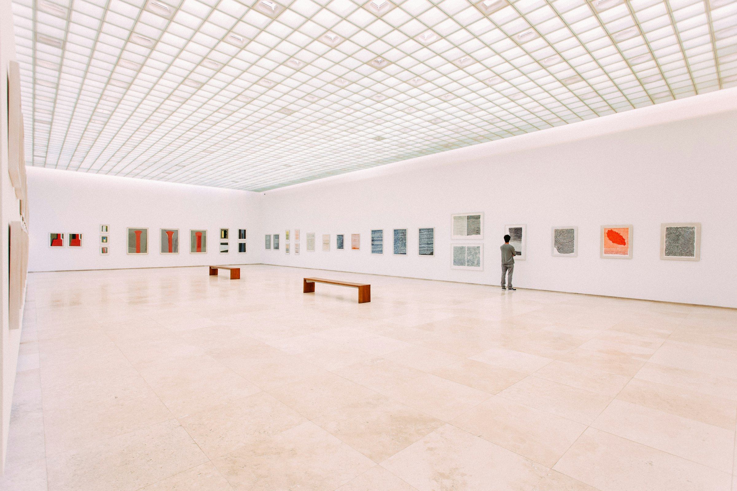 A white-walled gallery with artworks